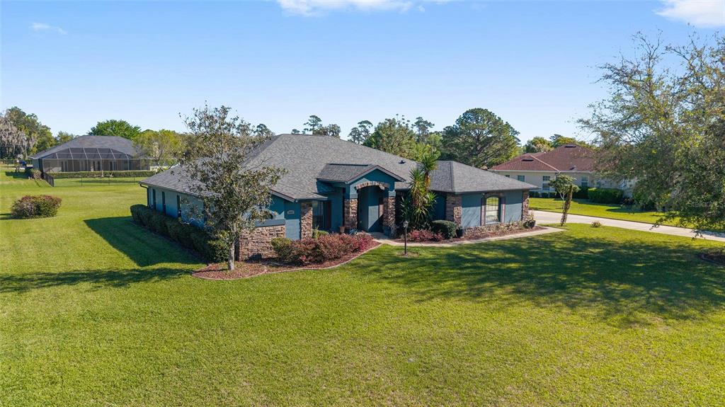 4037 Southeast 40th Street Ocala, FL 34480 - Photo 2 of 38 a view of a house with a yard and a patio