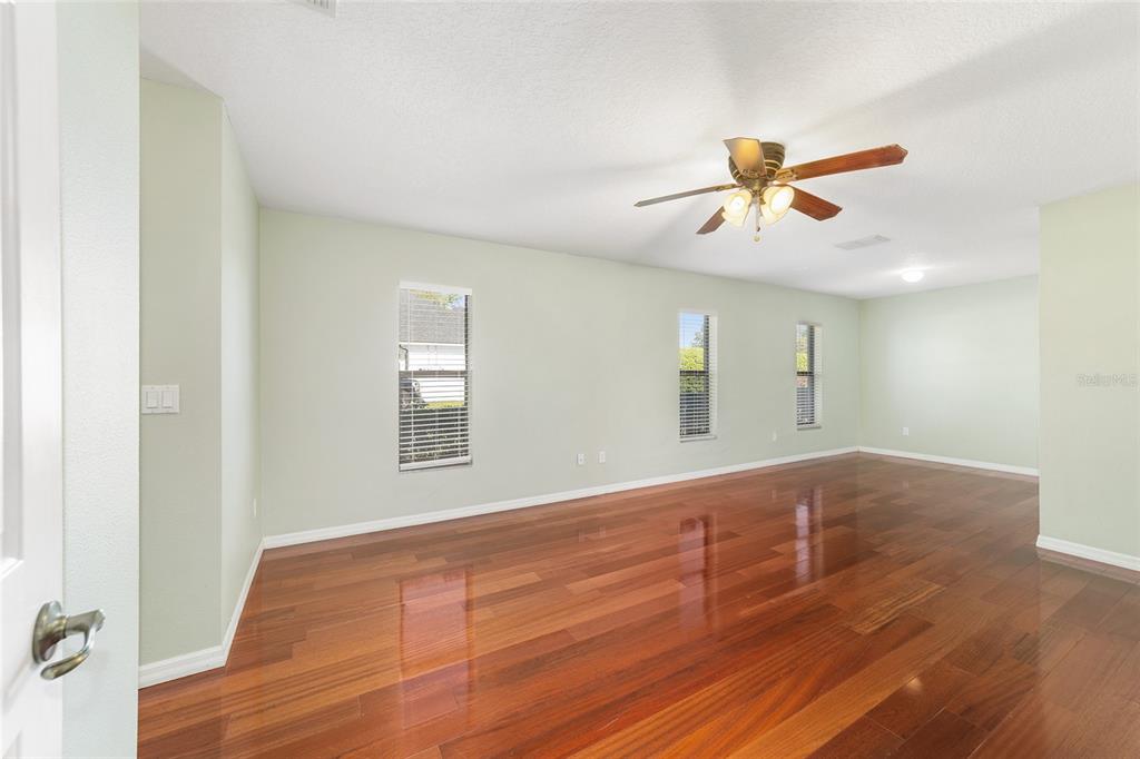 4037 Southeast 40th Street Ocala, FL 34480 - Photo 21 of 38 a view of empty room with wooden floor and fan