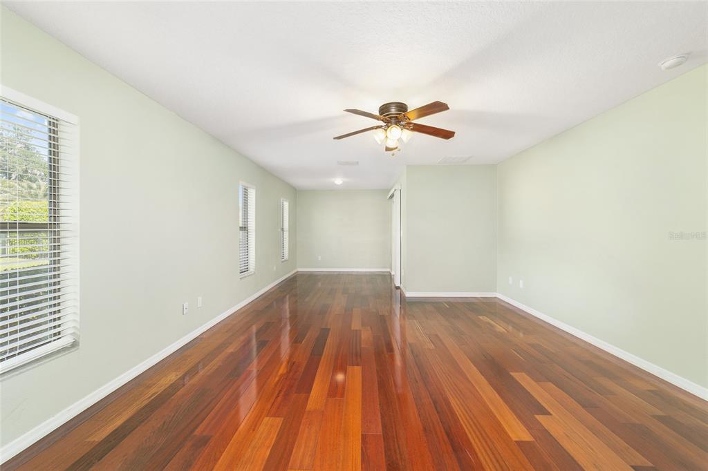 4037 Southeast 40th Street Ocala, FL 34480 - Photo 22 of 38 a view of room with hardwood floor and a ceiling fan