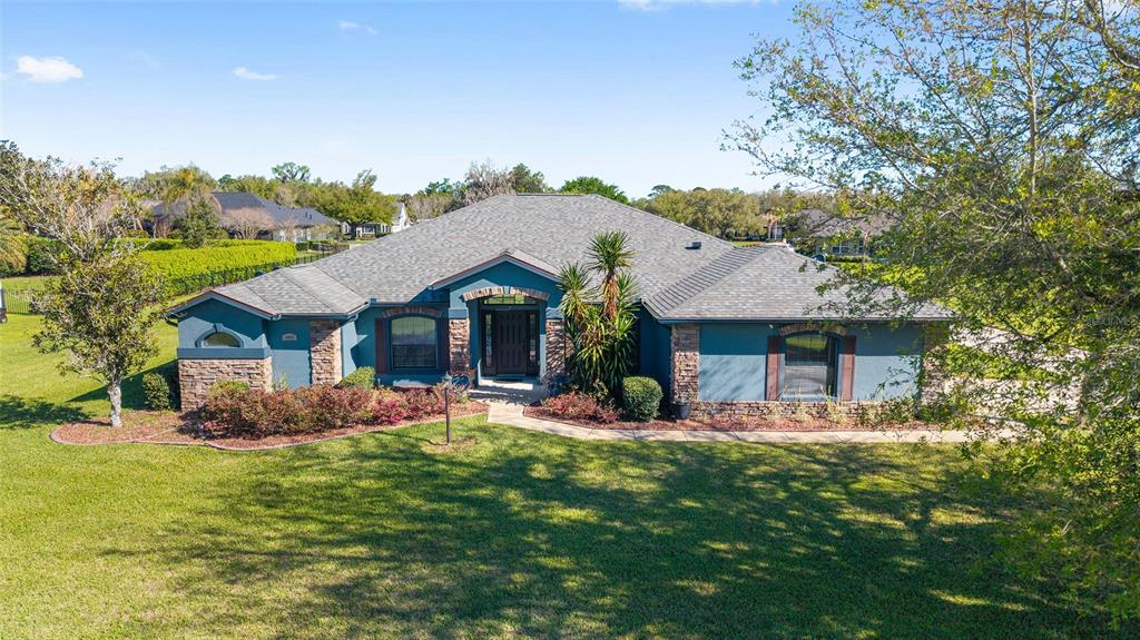 4037 Southeast 40th Street Ocala, FL 34480 - Photo 4 of 38 a front view of a house with a garden
