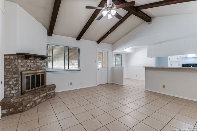 a view of an empty room with a fireplace