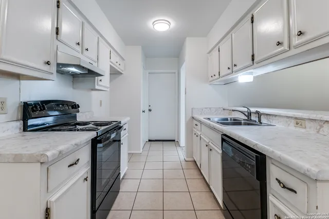 a kitchen that has a sink and a stove