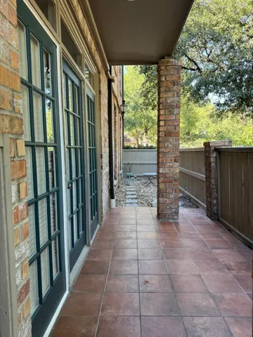 a view of a porch with wooden floor and outdoor space
