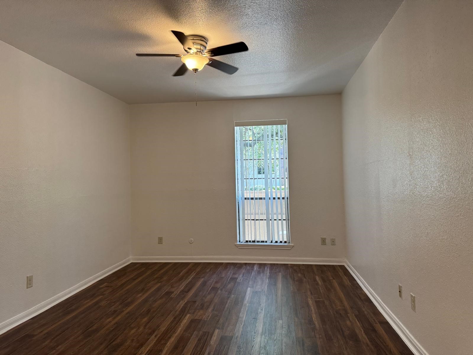 2425 Underwood Street, Unit 142 Houston, TX 77030 - Photo 3 of 38 an empty room with wooden floor and windows