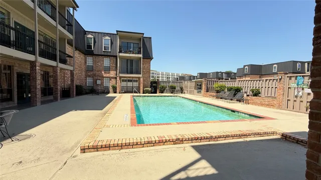 a view of a house with a swimming pool and sitting area