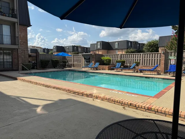 a view of a swimming pool with a lounge chairs