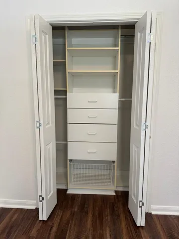 a view of walk in closet with empty racks