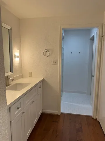 a bathroom with a double vanity sink and a mirror