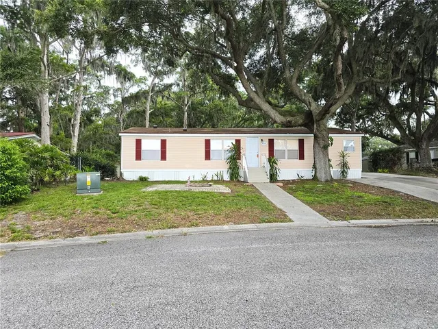 a view of backyard of house with green space