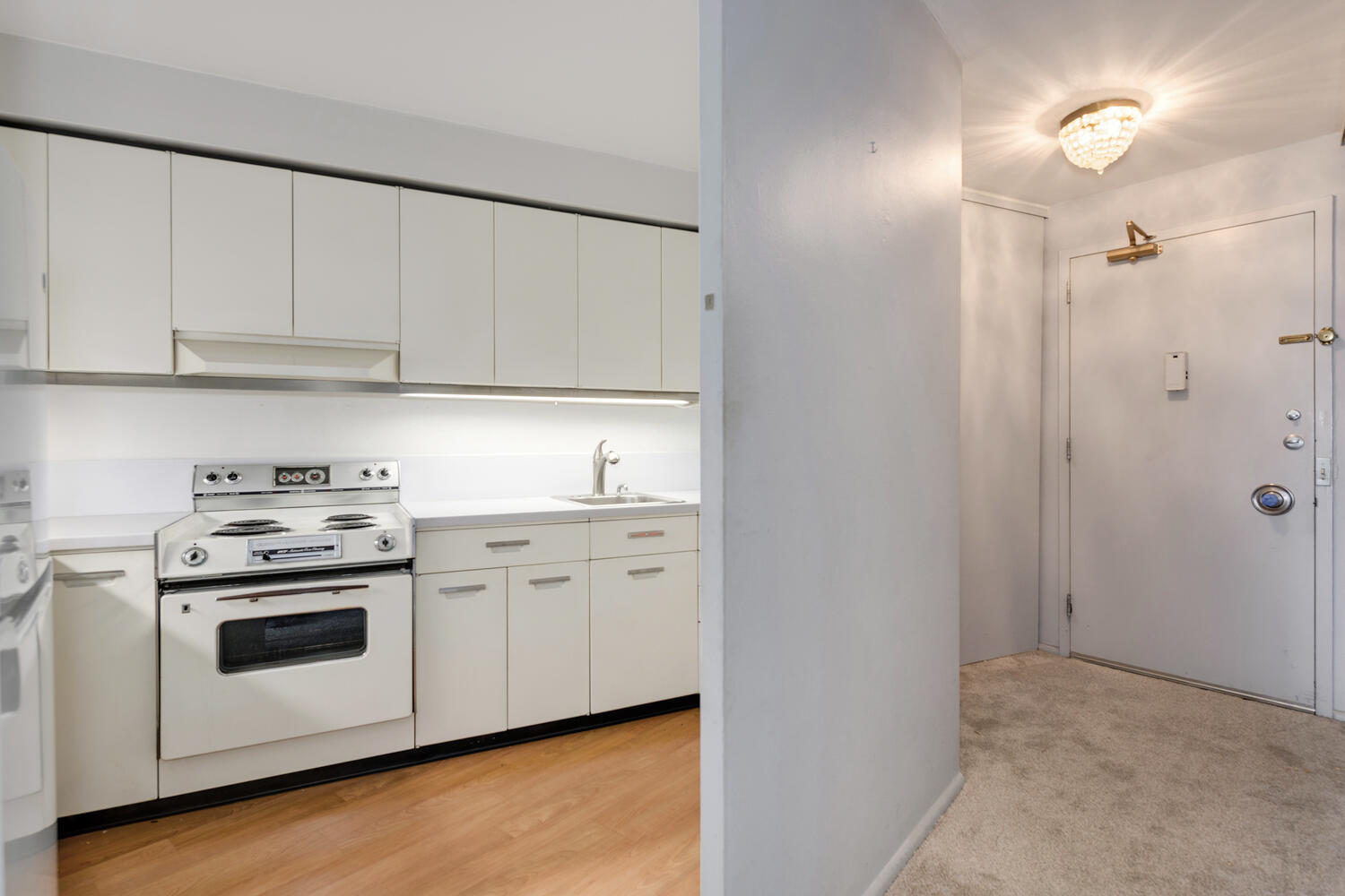 300 North State Street, Unit 3231 Chicago, IL 60654 - Photo 7 of 19 a kitchen with white cabinets and white appliances