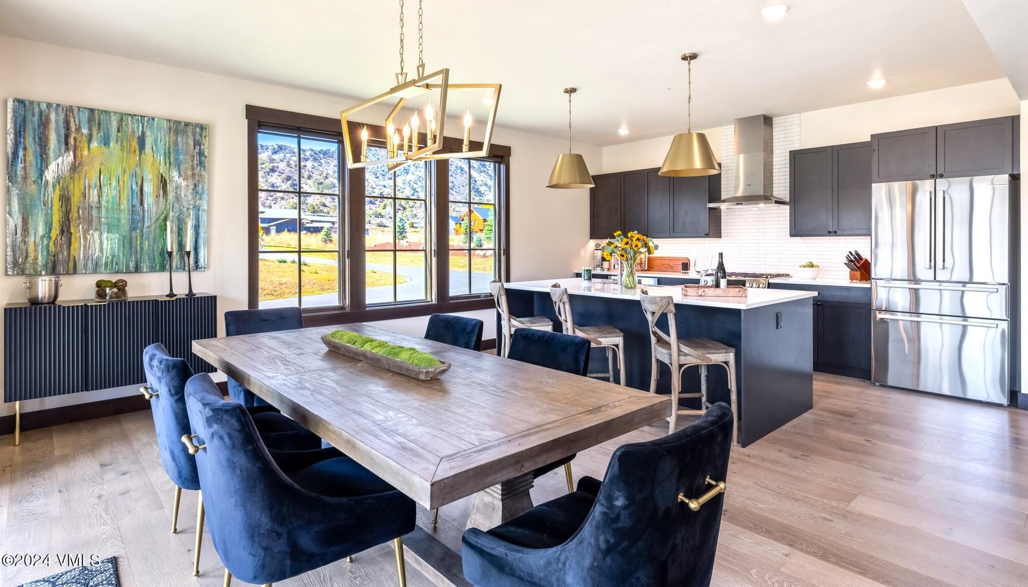 448 Hunters View Lane Eagle, CO 81631 - Photo 13 of 35 a view of a dining room with furniture window and wooden floor