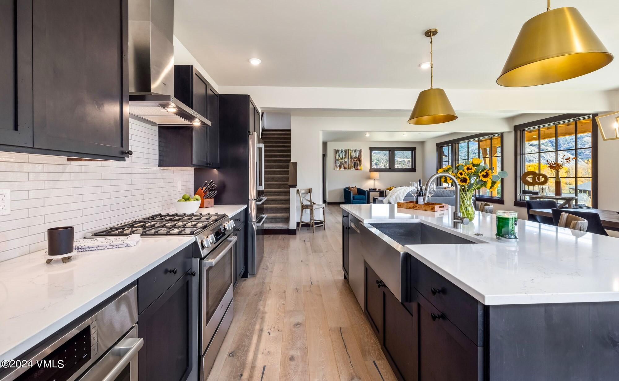 448 Hunters View Lane Eagle, CO 81631 - Photo 16 of 35 a kitchen with stainless steel appliances a sink a stove and a wooden floors