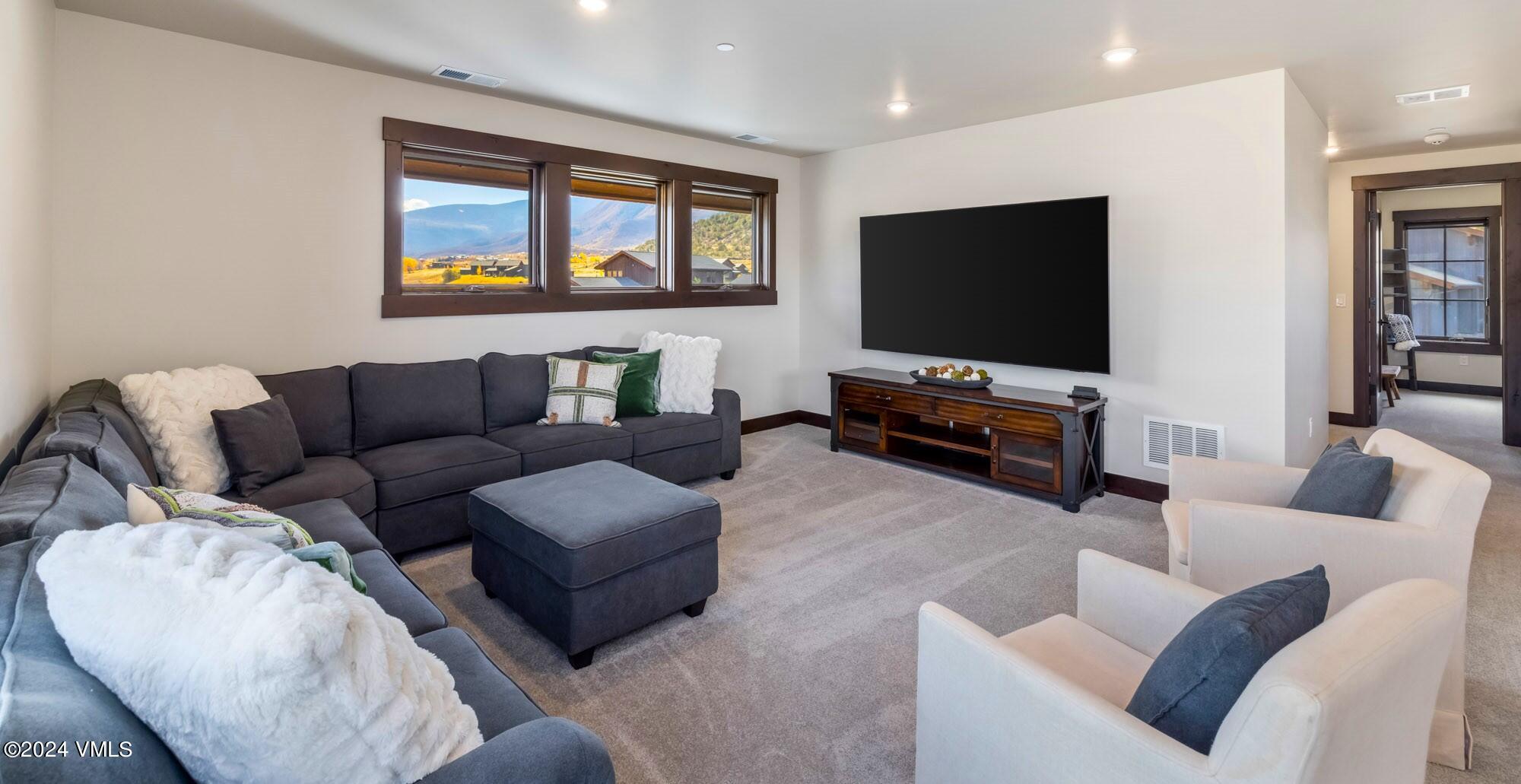 448 Hunters View Lane Eagle, CO 81631 - Photo 24 of 35 a living room with furniture and a flat screen tv