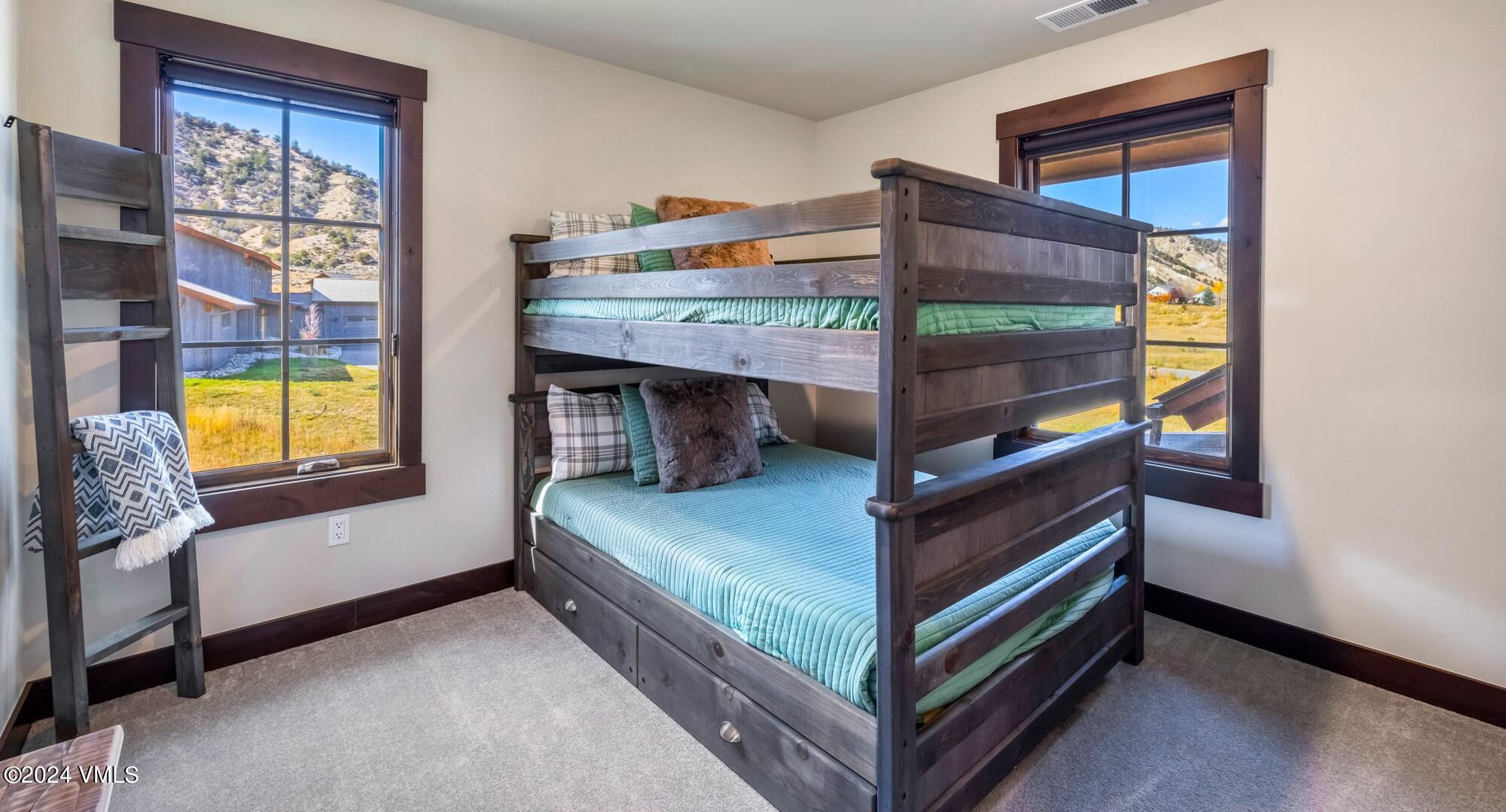 448 Hunters View Lane Eagle, CO 81631 - Photo 29 of 35 a bedroom with a bed and a window