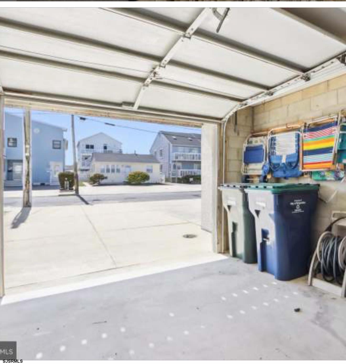 205 4th Street North, Unit 205B Brigantine, NJ 08203 - Photo 16 of 19 a kitchen with stainless steel appliances kitchen island granite countertop a refrigerator and a stove