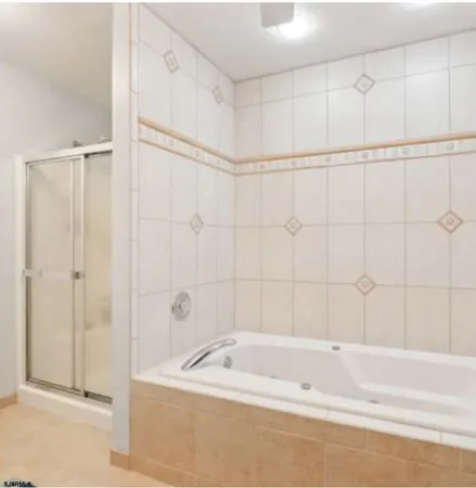a bathroom with a shower and a bath tub