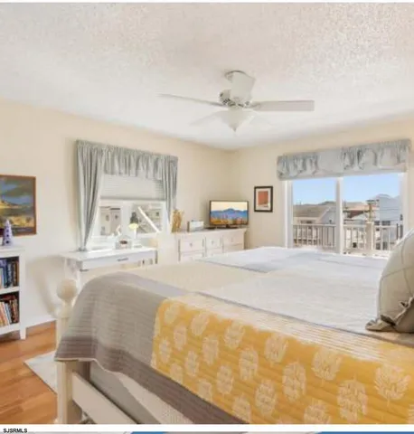a living room with a bed furniture and kitchen view