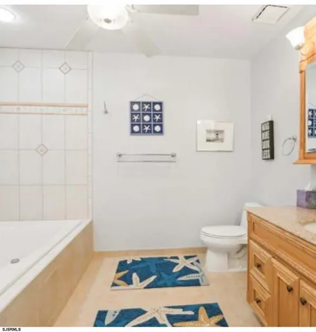 a bathroom with a sink a toilet and bathtub