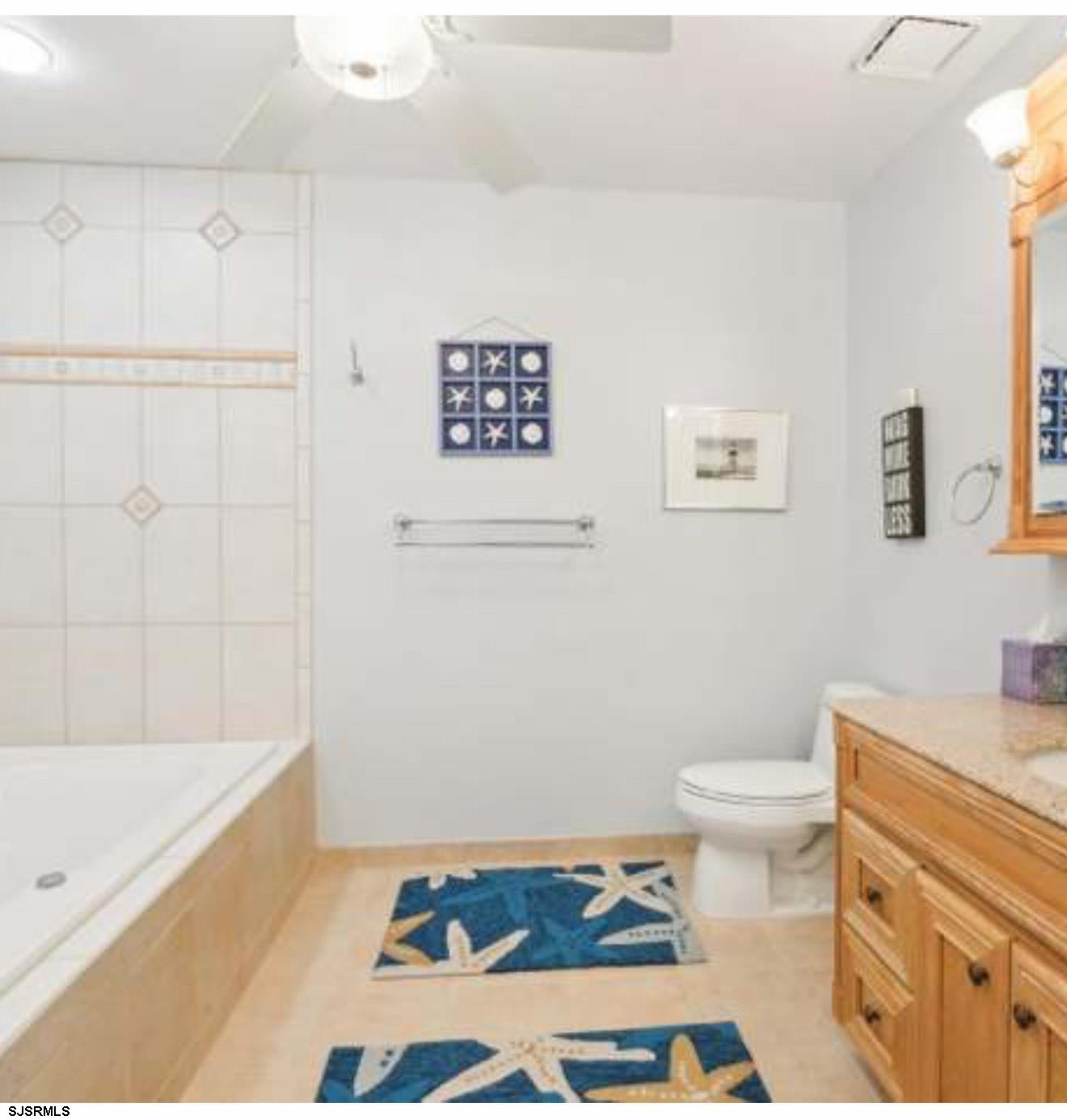 205 4th Street North, Unit 205B Brigantine, NJ 08203 - Photo 7 of 19 a bathroom with a sink a toilet and bathtub