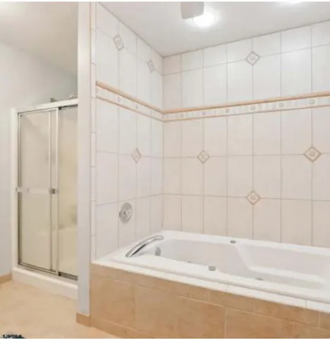 a bathroom with a shower and a bath tub