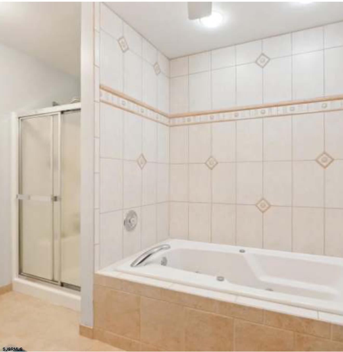 205 4th Street North, Unit 205B Brigantine, NJ 08203 - Photo 8 of 19 a bathroom with a shower and a bath tub