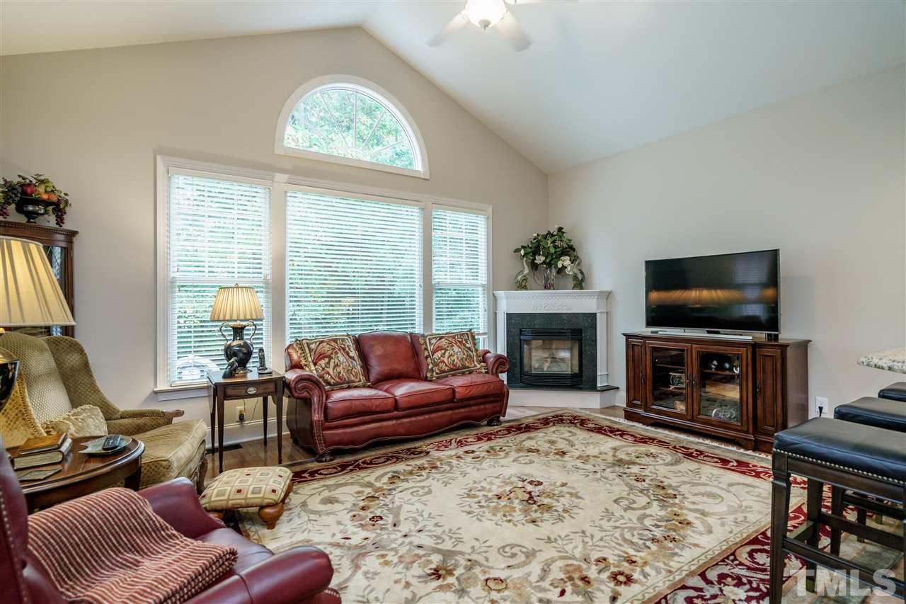 1901 Torrington Street Raleigh, NC 27615 - Photo 12 of 30 a living room with furniture a fireplace and a flat screen tv