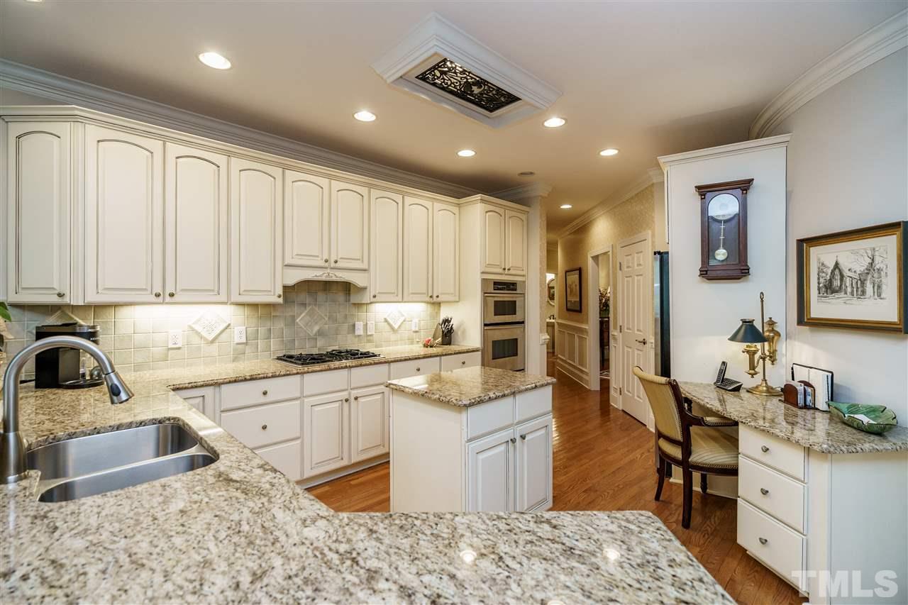 1901 Torrington Street Raleigh, NC 27615 - Photo 13 of 30 a kitchen with stainless steel appliances granite countertop a sink stove and refrigerator