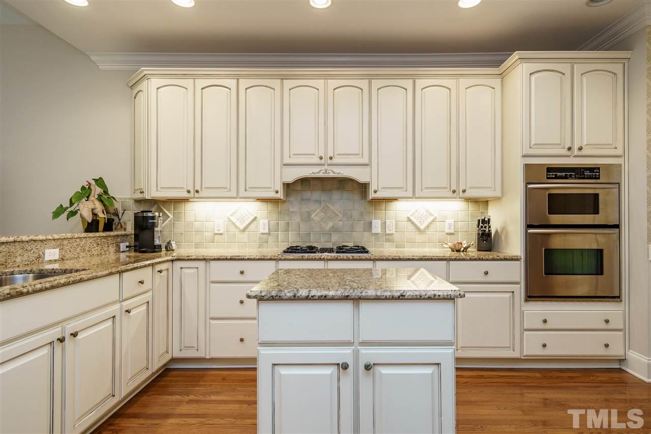 1901 Torrington Street Raleigh, NC 27615 - Photo 14 of 30 a kitchen with granite countertop white cabinets and stainless steel appliances