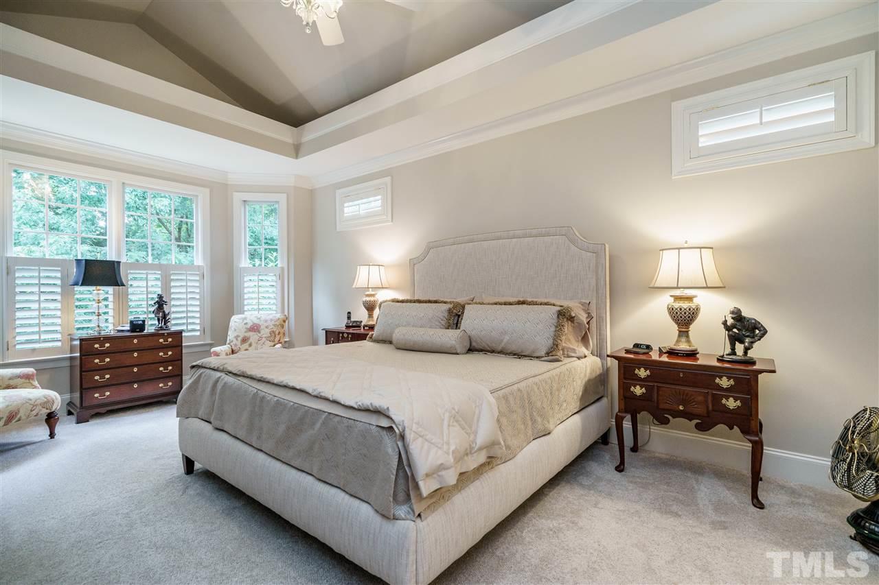 1901 Torrington Street Raleigh, NC 27615 - Photo 17 of 30 a bedroom with a bed and a chandelier