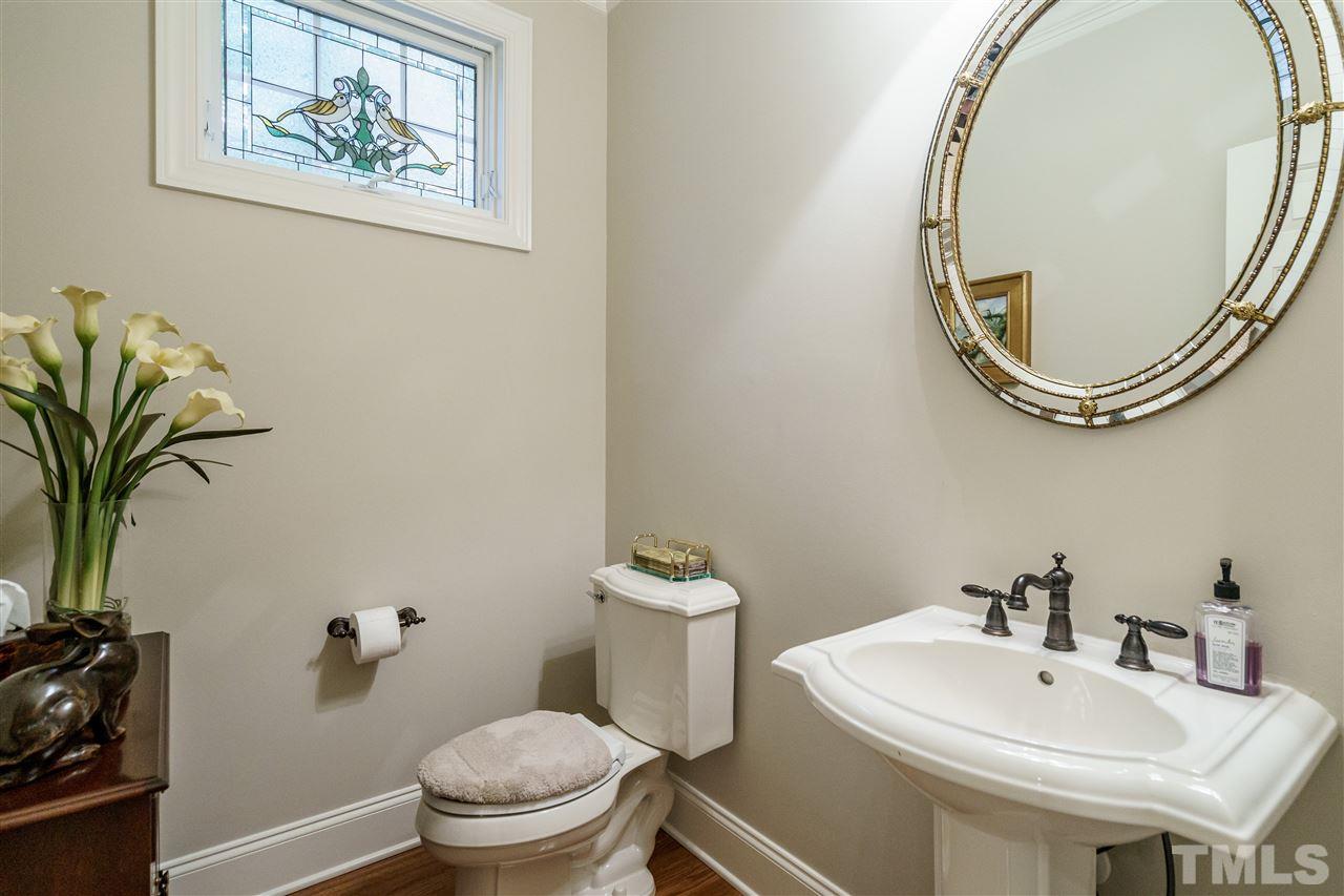 1901 Torrington Street Raleigh, NC 27615 - Photo 19 of 30 a bathroom with a toilet and a sink