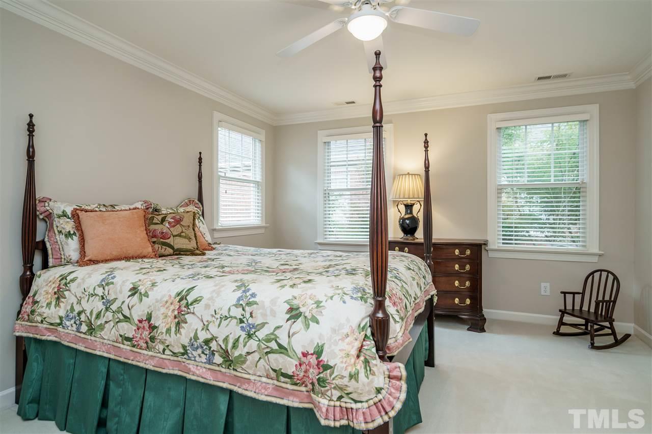 1901 Torrington Street Raleigh, NC 27615 - Photo 23 of 30 a bedroom with a bed and a chandelier