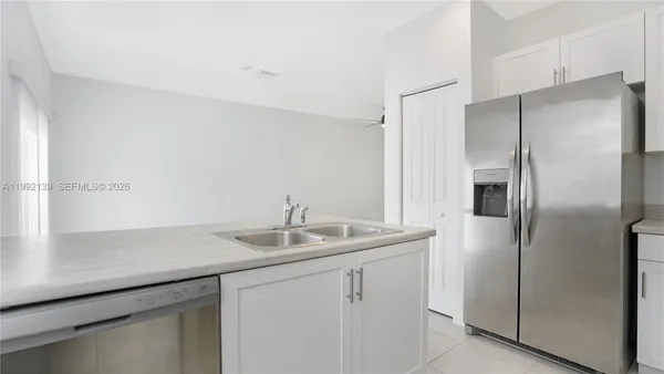 a kitchen with a sink and refrigerator