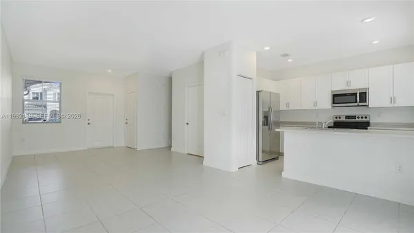 a kitchen with stainless steel appliances a refrigerator and a stove top oven