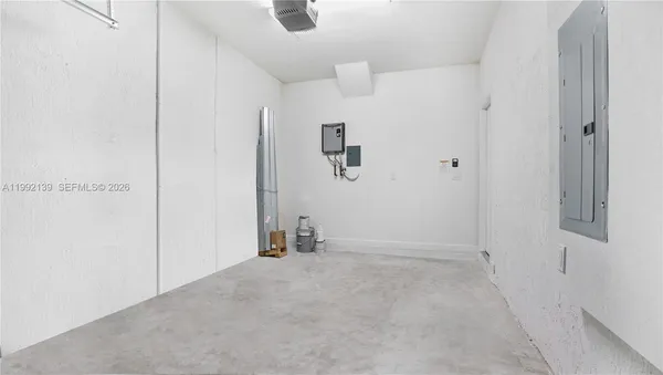 an empty room with closet and windows