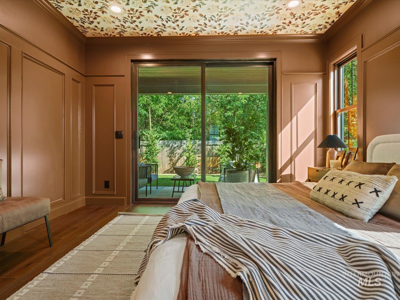 2834 West Cassia Street Boise, ID 83705 - Photo 13 of 15 Bedroom with crown molding, access to outside, wood finished floors, and a decorative wall