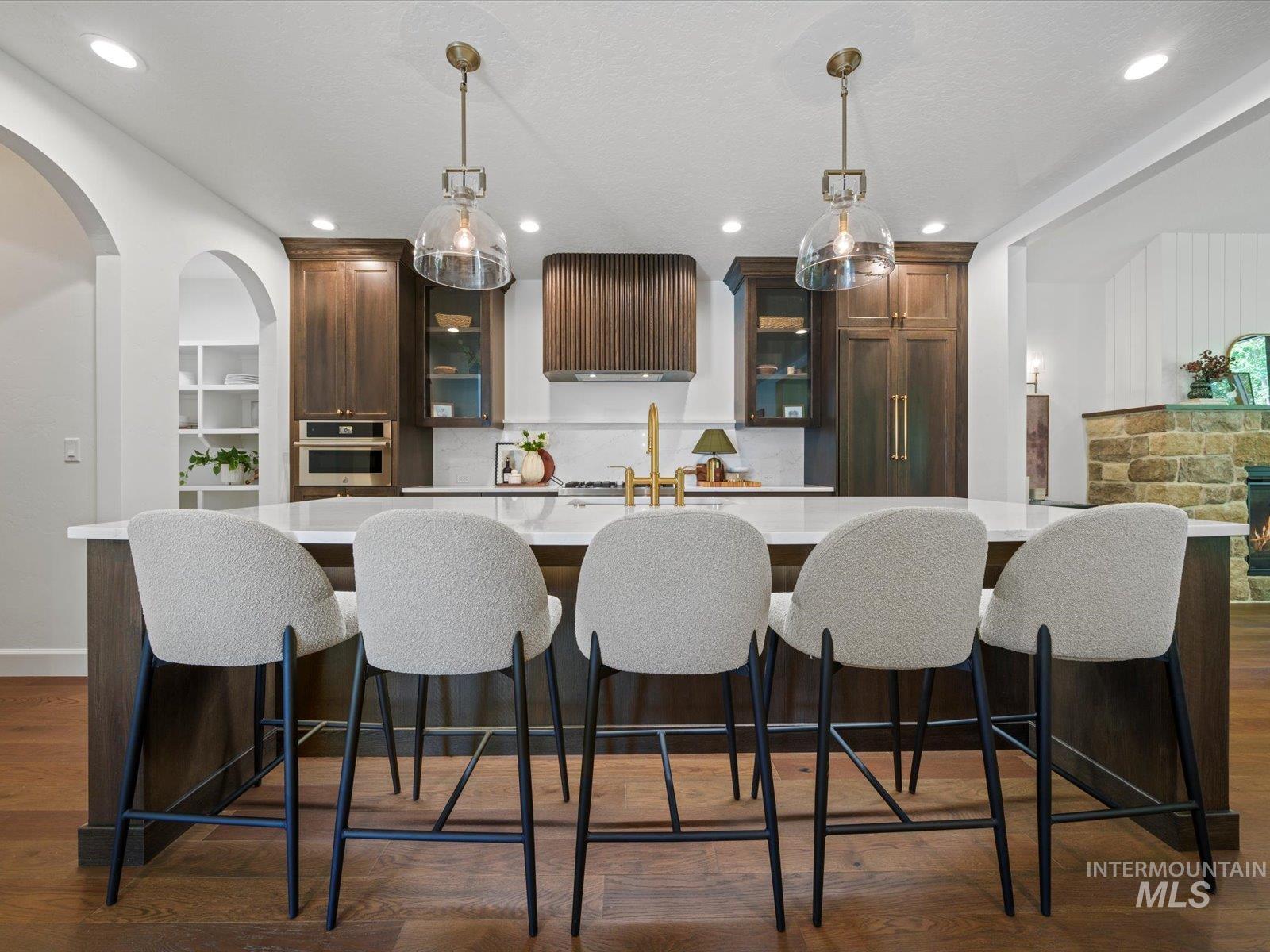 2834 West Cassia Street Boise, ID 83705 - Photo 2 of 15 Kitchen with a kitchen breakfast bar, dark brown cabinetry, dark wood-style floors, hanging light fixtures, and recessed lighting