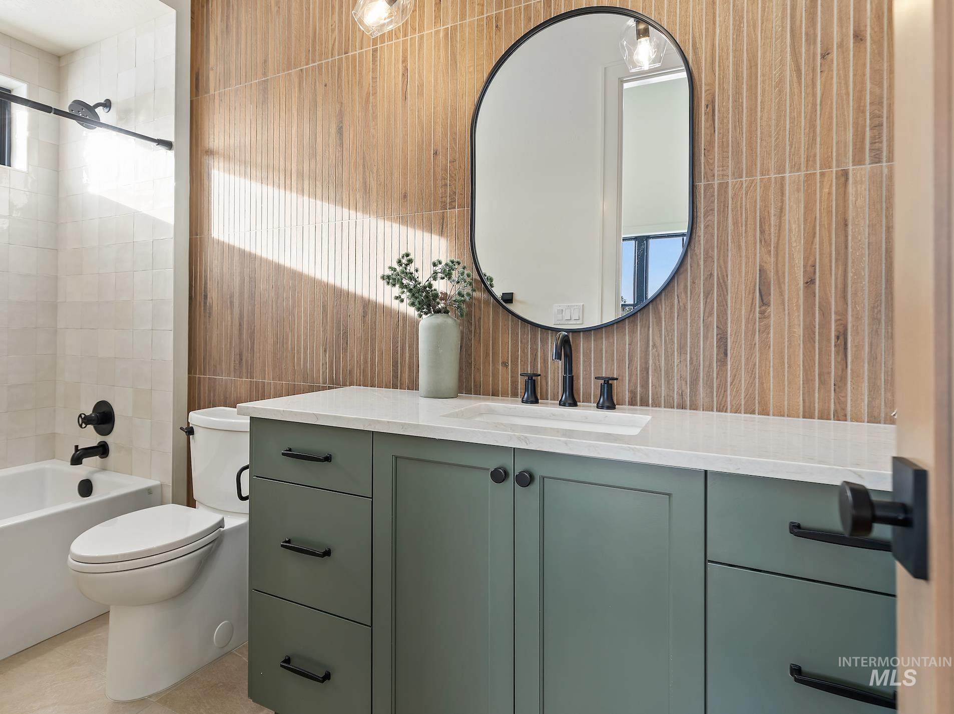 2834 West Cassia Street Boise, ID 83705 - Photo 9 of 15 Bathroom featuring vanity, shower / bathtub combination, tile walls, and light tile patterned floors