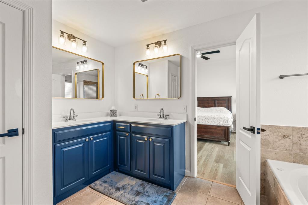 205 Crepe Myrtle Lane Murphy, TX 75094 - Photo 19 of 33 a spacious bathroom with a tub sink and mirror