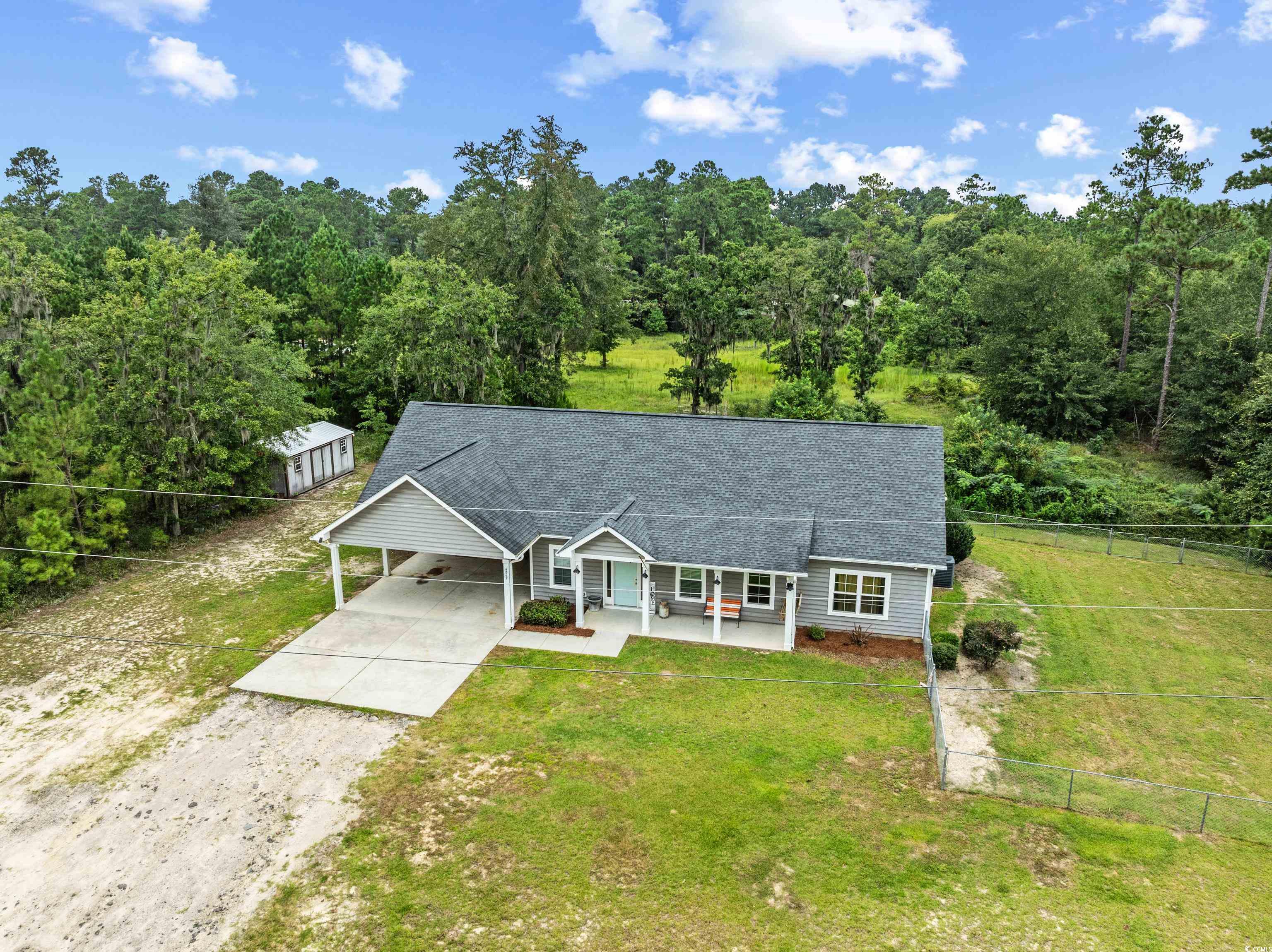 4867 Wolf Trail Conway, SC 29527 - Photo 2 of 31 View of front of home featuring concrete driveway, roof with shingles, an attached carport, and a front yard