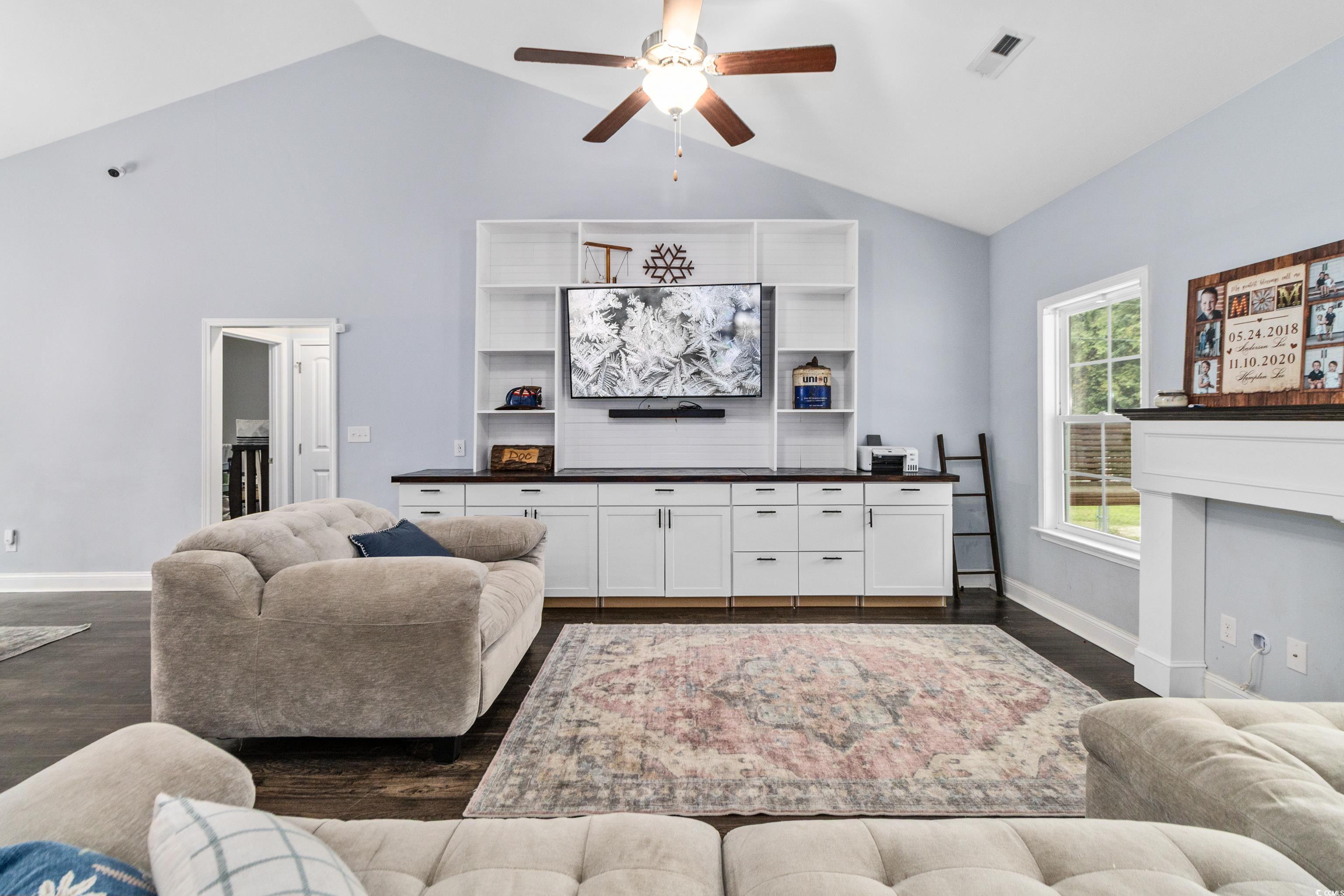 4867 Wolf Trail Conway, SC 29527 - Photo 6 of 31 Living room featuring vaulted ceiling, a ceiling fan, dark wood-style floors, and a fireplace