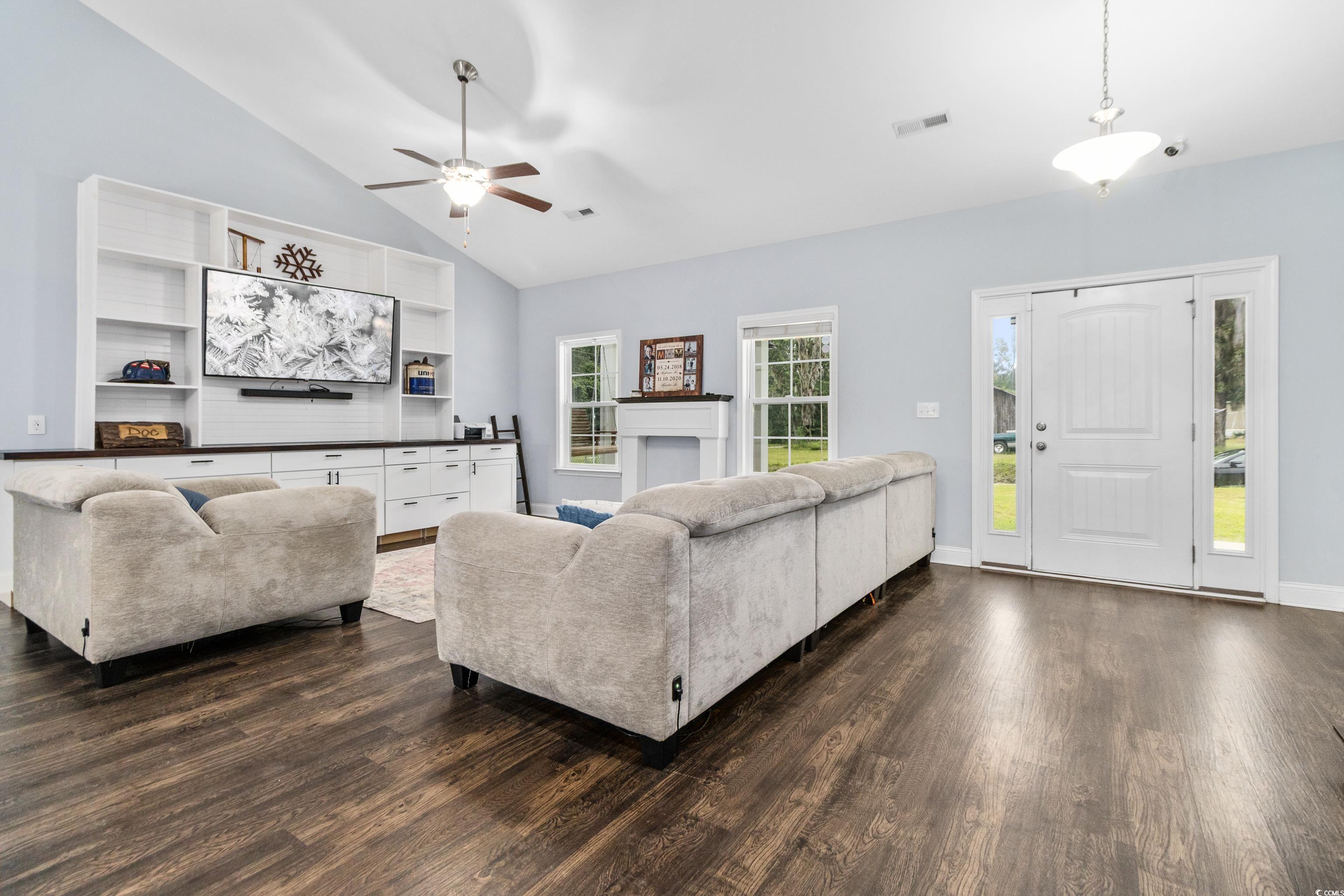 4867 Wolf Trail Conway, SC 29527 - Photo 8 of 31 Living room with vaulted ceiling, dark wood-type flooring, and a ceiling fan