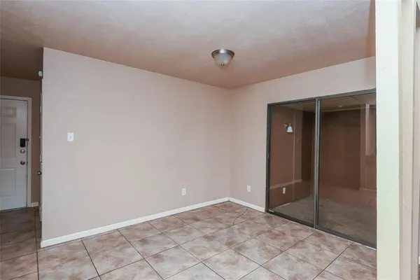 an empty room with a ceiling fan and carpet