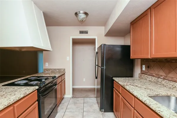 a kitchen with a stove top oven sink and cabinets