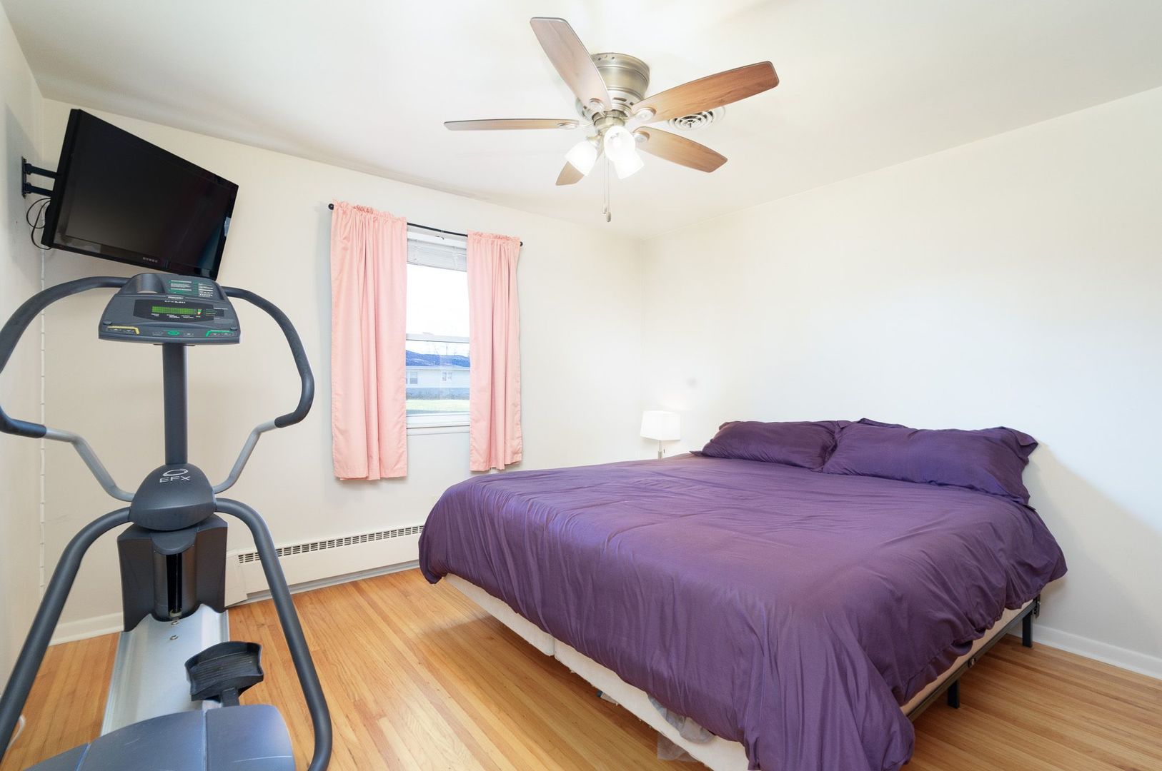 1008 Westminster Road Joliet, IL 60435 - Photo 12 of 28 a bedroom with a bed and a flat screen tv