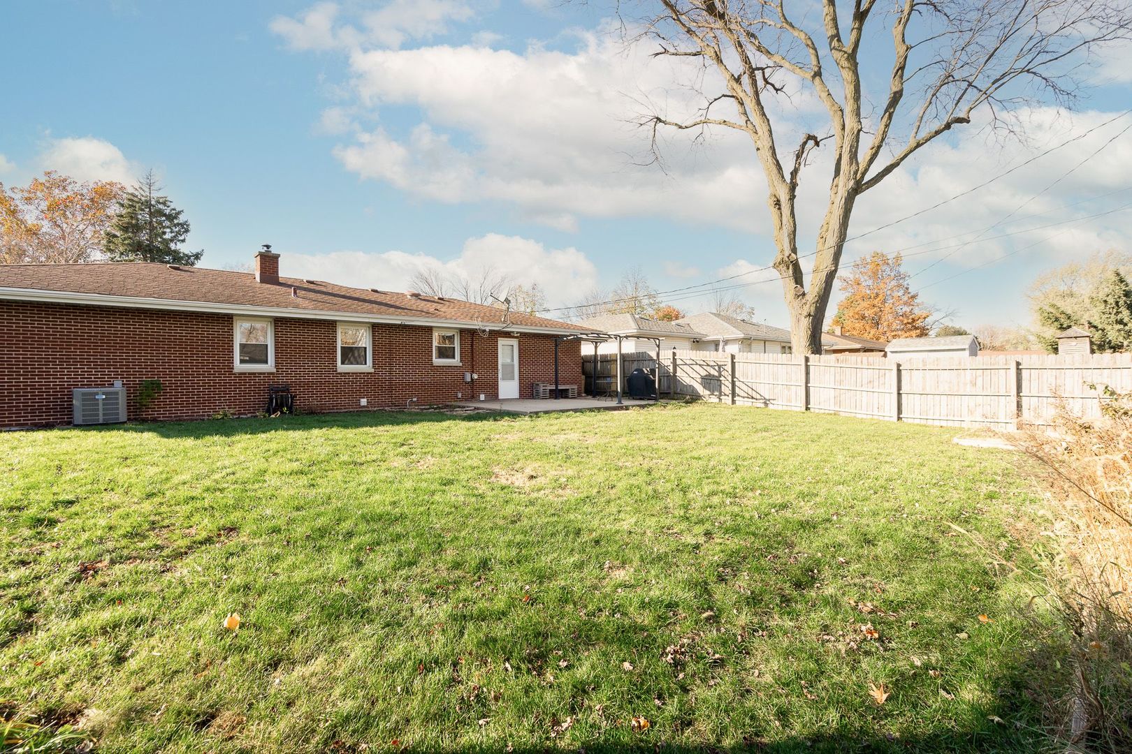 1008 Westminster Road Joliet, IL 60435 - Photo 27 of 28 a view of a house with a big yard and large trees