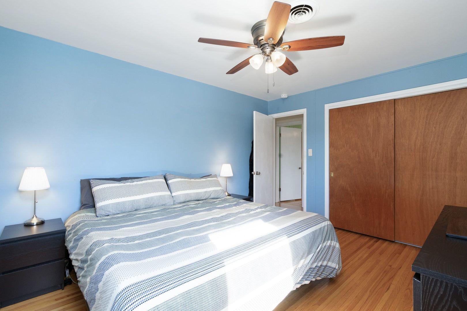 1008 Westminster Road Joliet, IL 60435 - Photo 8 of 28 a bedroom with a bed and a chandelier