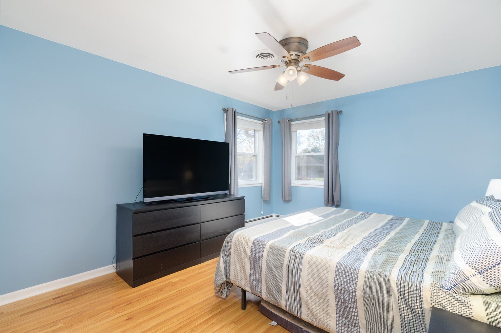 1008 Westminster Road Joliet, IL 60435 - Photo 9 of 28 a bedroom with a bed and a flat screen tv