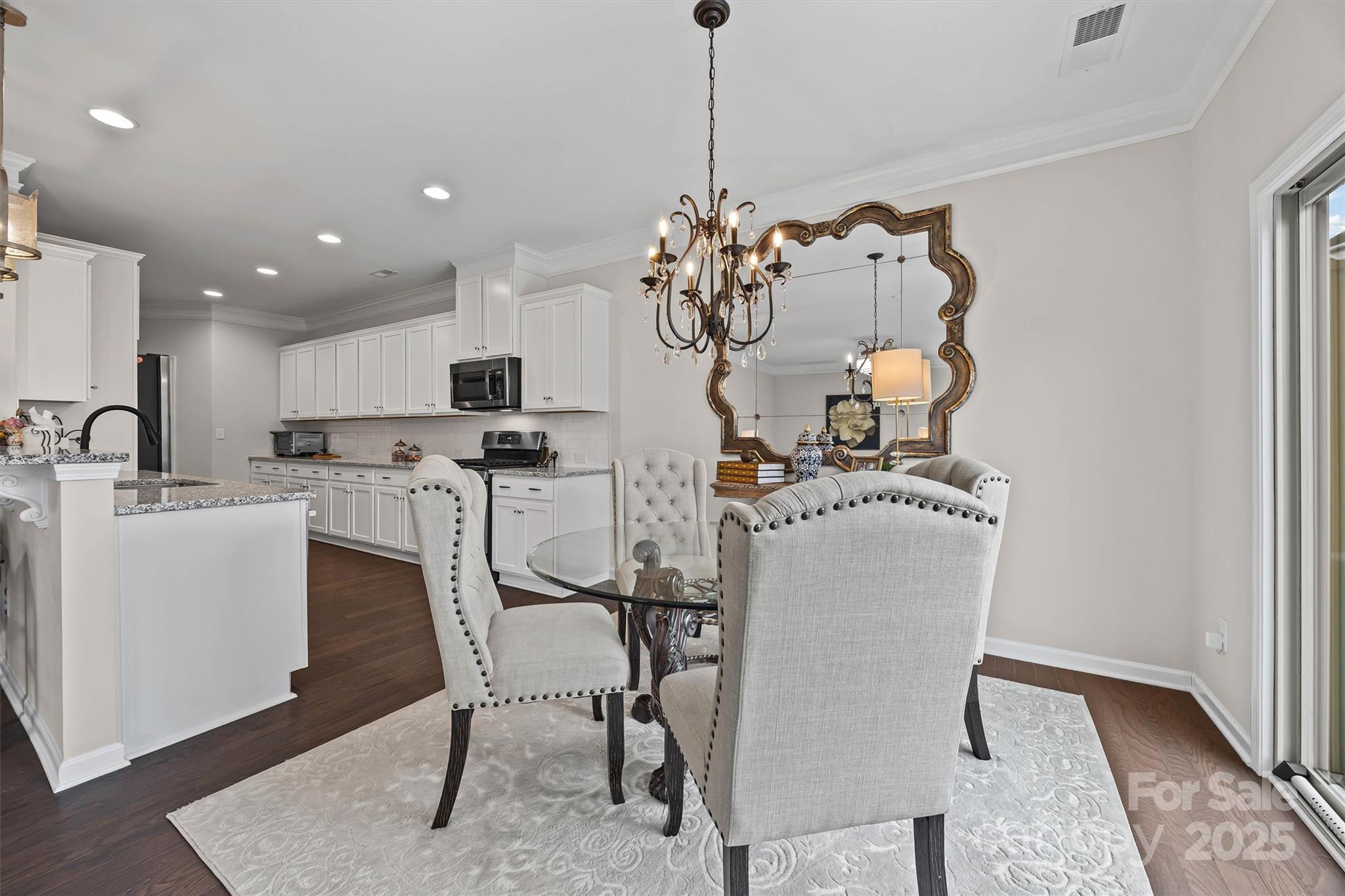 632 Amber Meadows Way Tega Cay, SC 29708 - Photo 11 of 48 a view of a dining room with furniture and wooden floor
