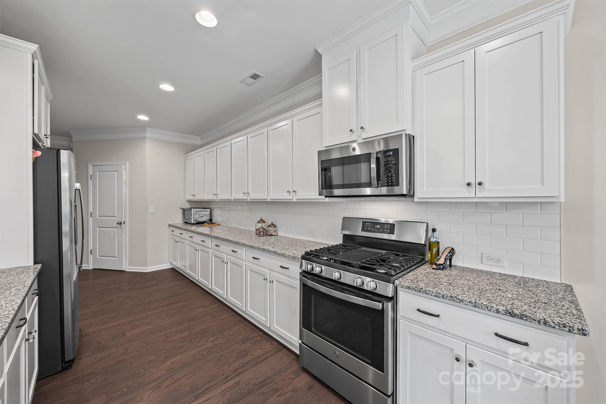 632 Amber Meadows Way Tega Cay, SC 29708 - Photo 13 of 48 a kitchen with stainless steel appliances granite countertop a stove a sink and a refrigerator