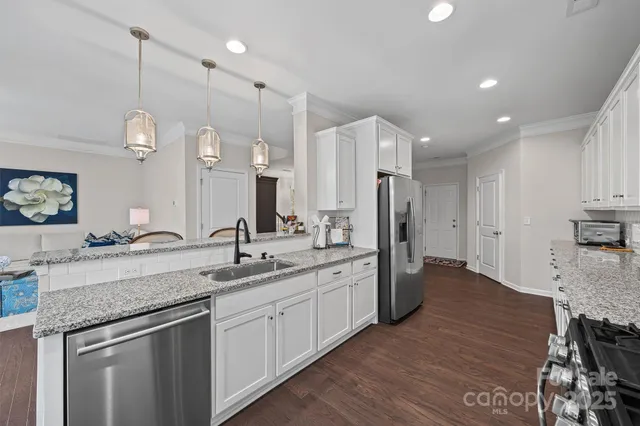 a kitchen with a sink stove and refrigerator
